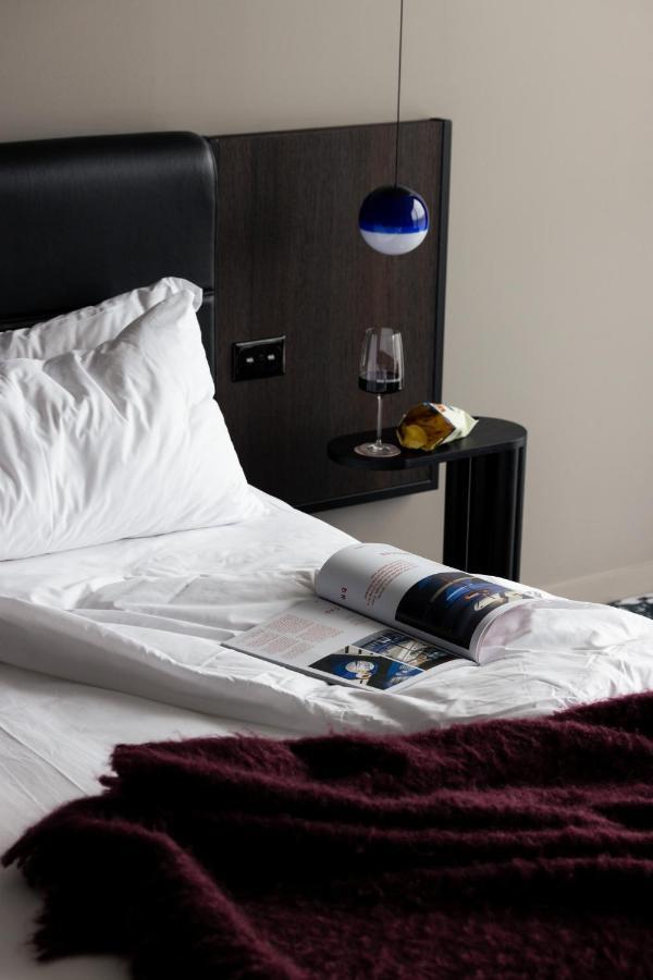 Ebb-ダニーデン エクステリア 写真 A bed with a magazine and a wine bottle